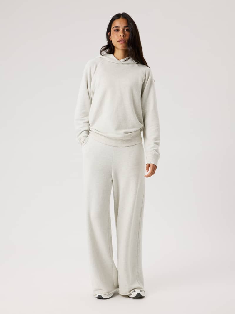 Full-body front view of a model in Studio French Terry Oversized Sweatpants in Tofu Melange (Beige) for studio movement.