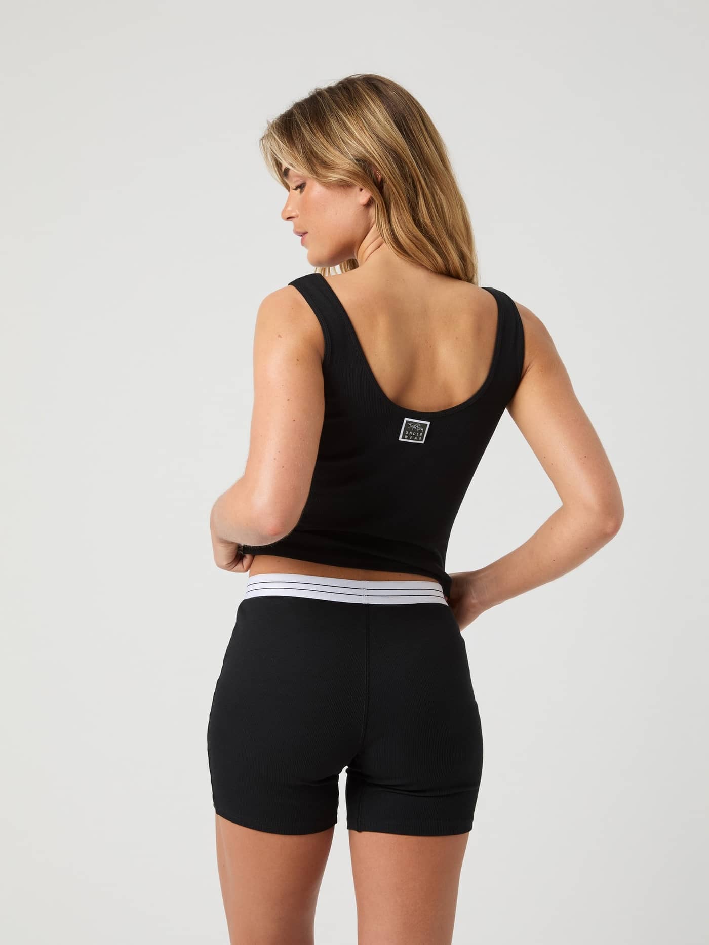 Back view of the Core Original Rib Tank in Black Beauty (Black) featuring a soft rib fabric and logo label at the back. - Image 2