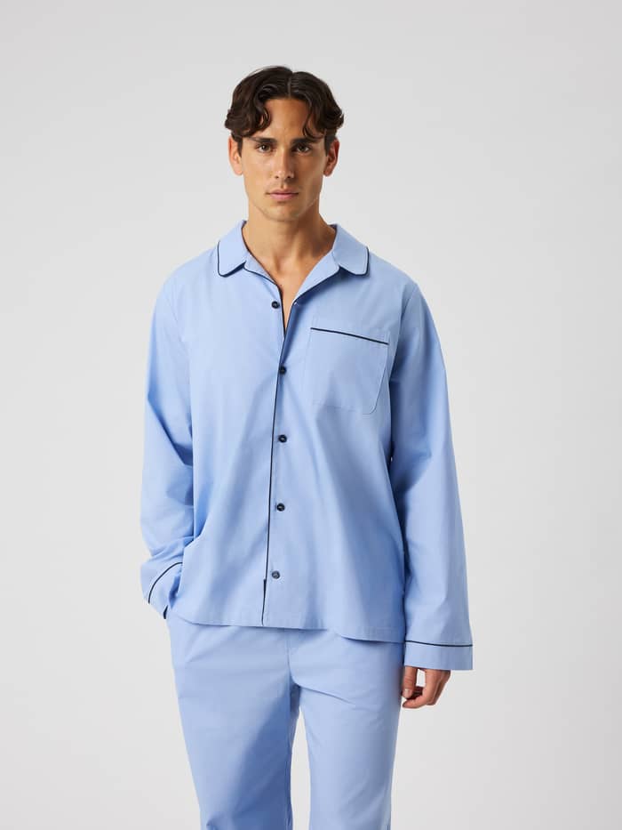 Front view of the Core Premium Pyjama Shirt in Lavender Lustre (blue) featuring a button placket, chest pocket, and piping.