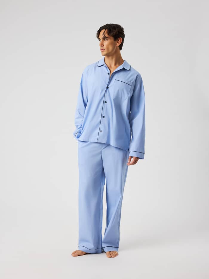Man wearing the Core Premium Pyjama Shirt in Lavender Lustre (Blue) with long sleeves, button placket, and piped details.