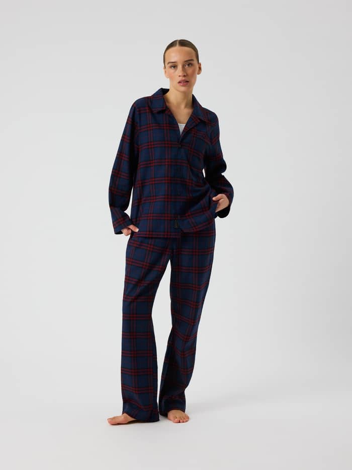 Front view of a model wearing the Core Flannel Pyjama Shirt in a blue and red tartan check pattern.