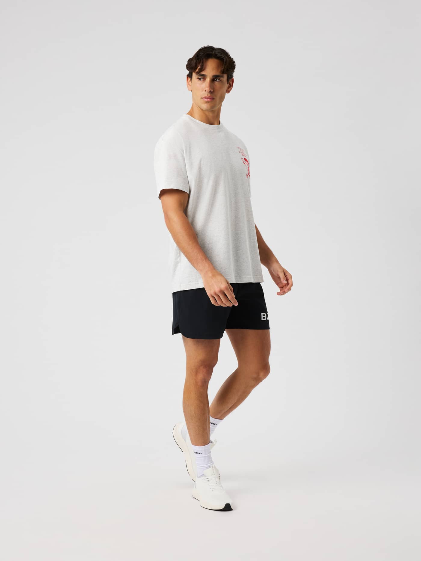 Male model wearing the Borg Gym Oversized T-Shirt in Ultra Light Grey Melange (grey) for training. - Image 3