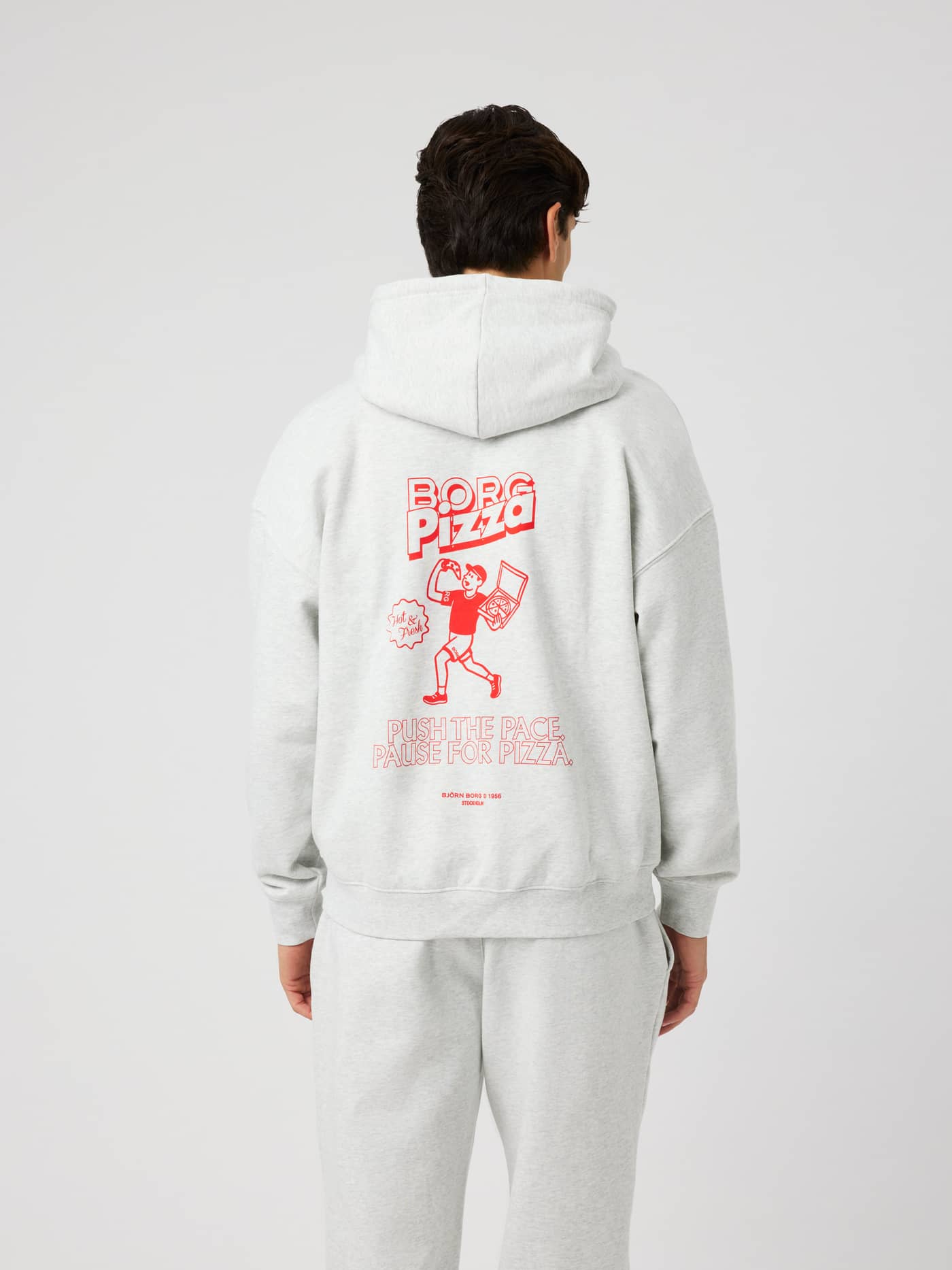 Back view of the Borg Oversized Hoodie in Ultra Light Grey Melange (Grey) featuring a red graphic print and text on the back. - Image 2
