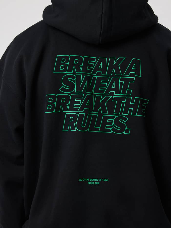 Back view of the Borg Oversized Hoodie in black beauty featuring green text print on the back.