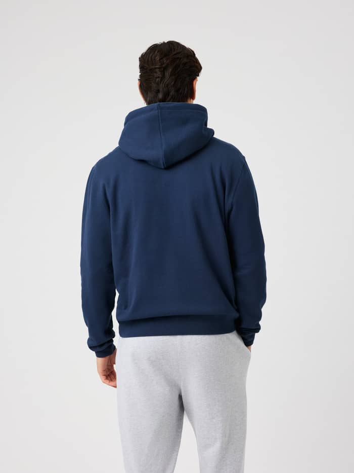 Back view of a male model wearing the Borg Classic Print Hoodie in Dress Blues for training.