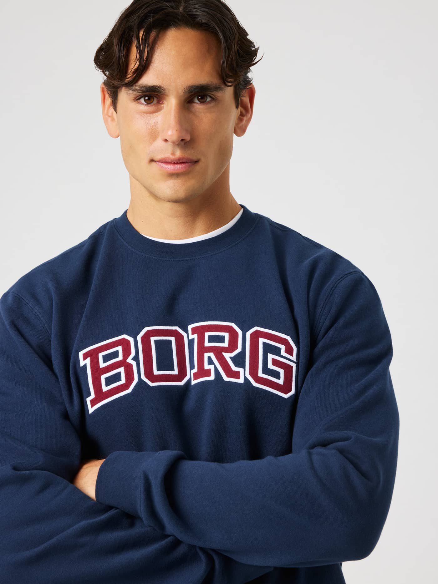 Close-up of the Borg Classic Print Sweatshirt in Dress Blues (Navy) featuring a burgundy and white BORG chest print. - Image 1