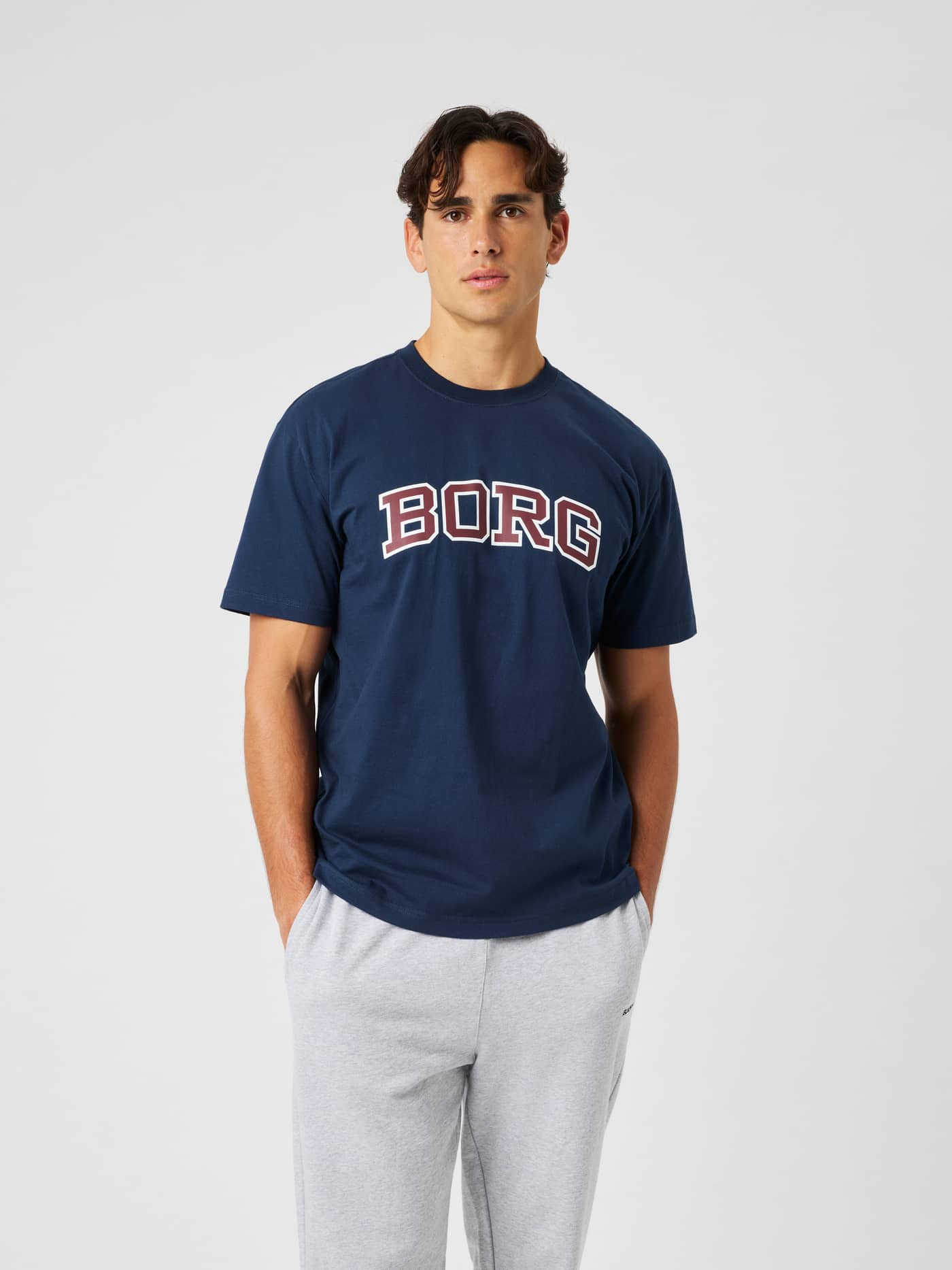 Male model wearing the Borg Classic Print T-Shirt in Dress Blues (Navy) with a collegiate BORG logo print on the chest. - Image 2