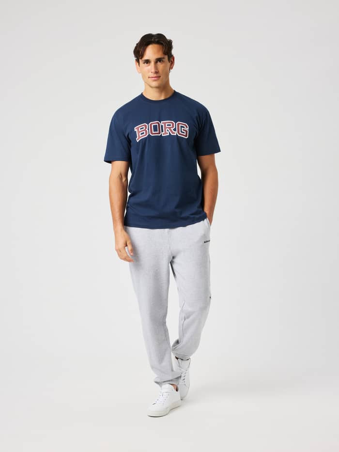 Man wearing the Borg Classic Print T-Shirt in Dress Blues (Navy) featuring a collegiate BORG logo on the chest.