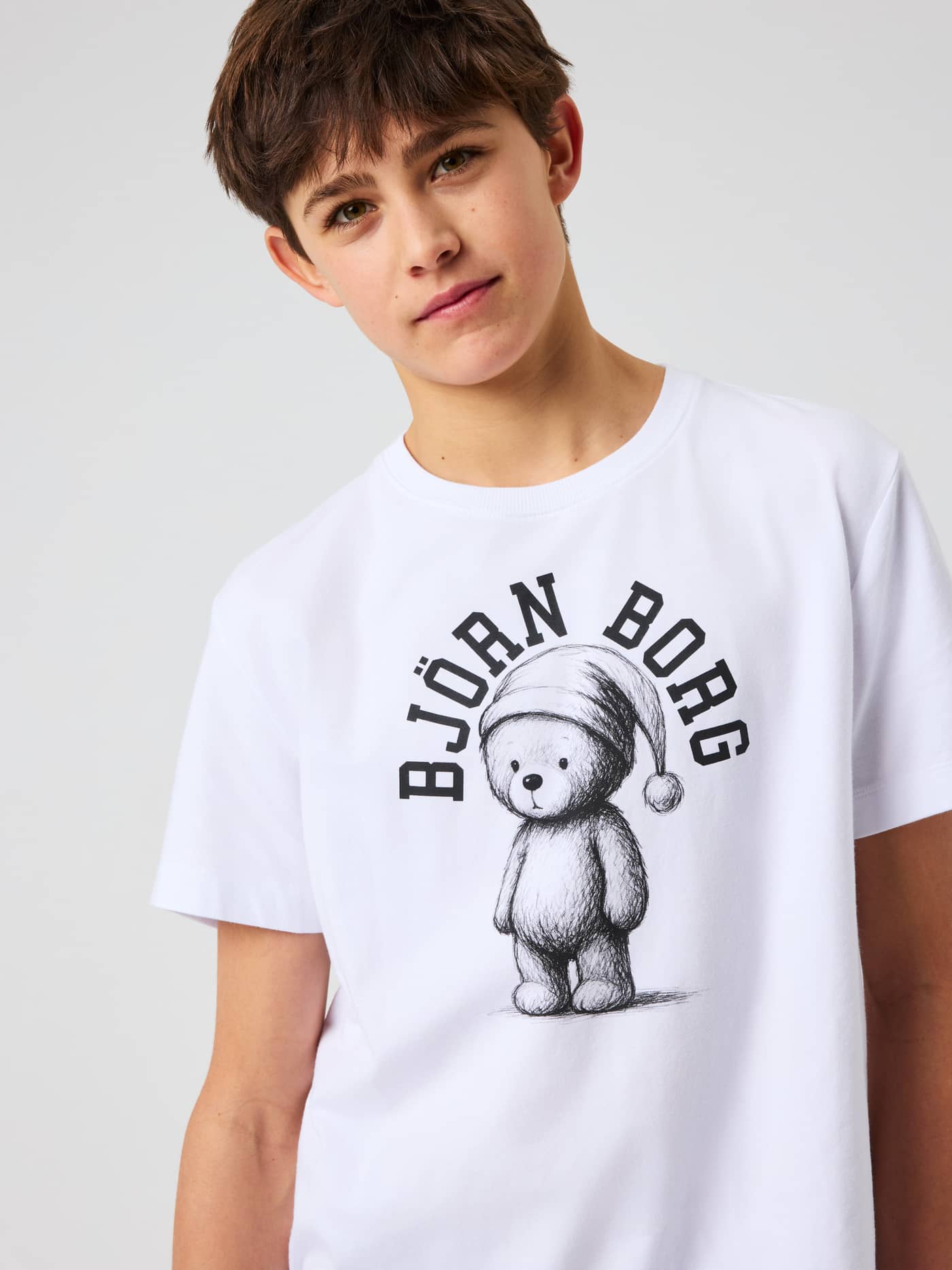 Close-up of the Core Loungewear T-Shirt in Brilliant White with a festive teddy bear graphic. - Image 4