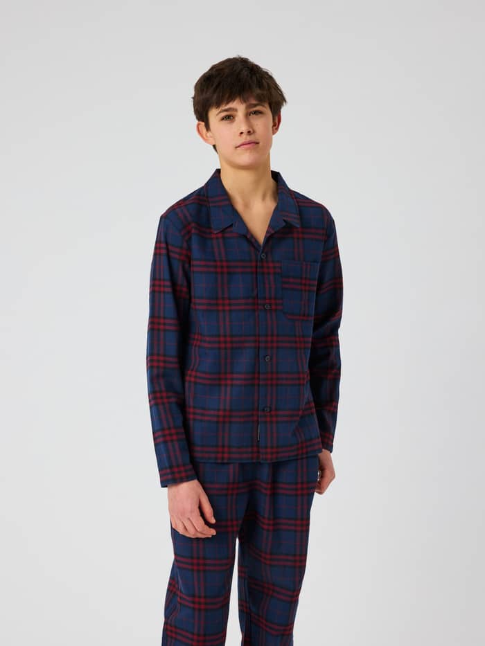 Front view of a kid wearing the checked Core Flannel Pyjama Set 2-pack in multi colors.