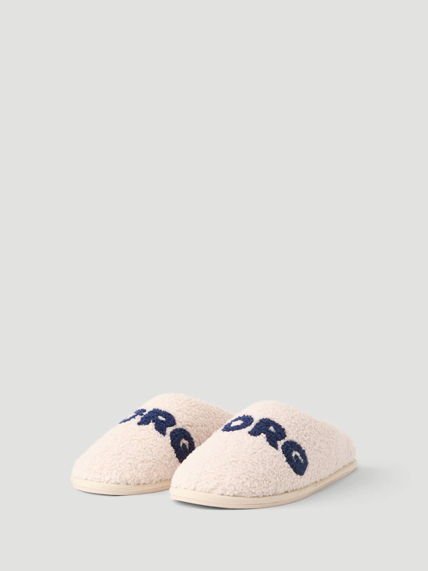 Haven Slipper in white with navy Borg branding on the vamp. - Image 1