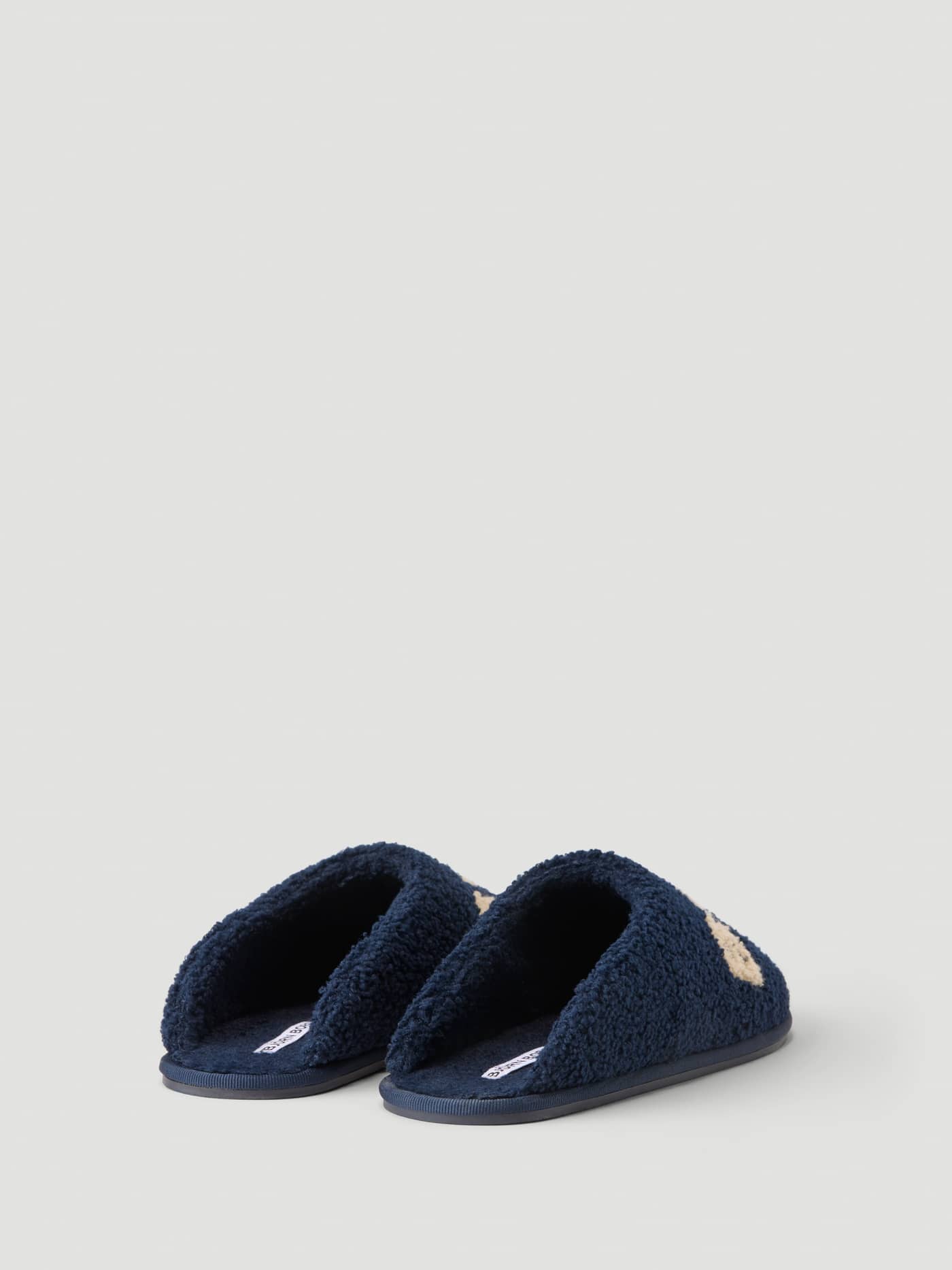 Side view of the Haven Slipper in Peacoat / Tofu showcasing the warm pile finish and slip-on design. - Image 2