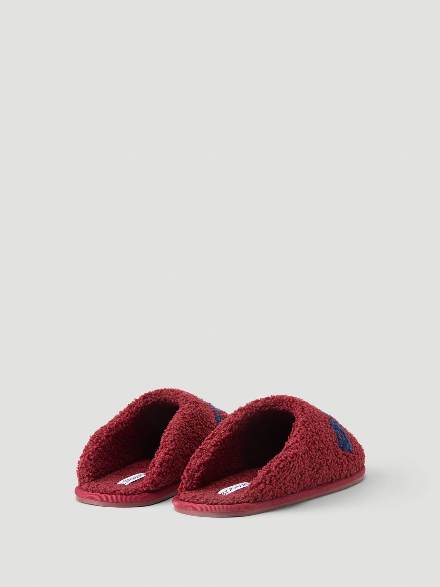 Back view of the Haven Slipper in Cabernet and Peacoat featuring soft pile and branded details. - Image 2