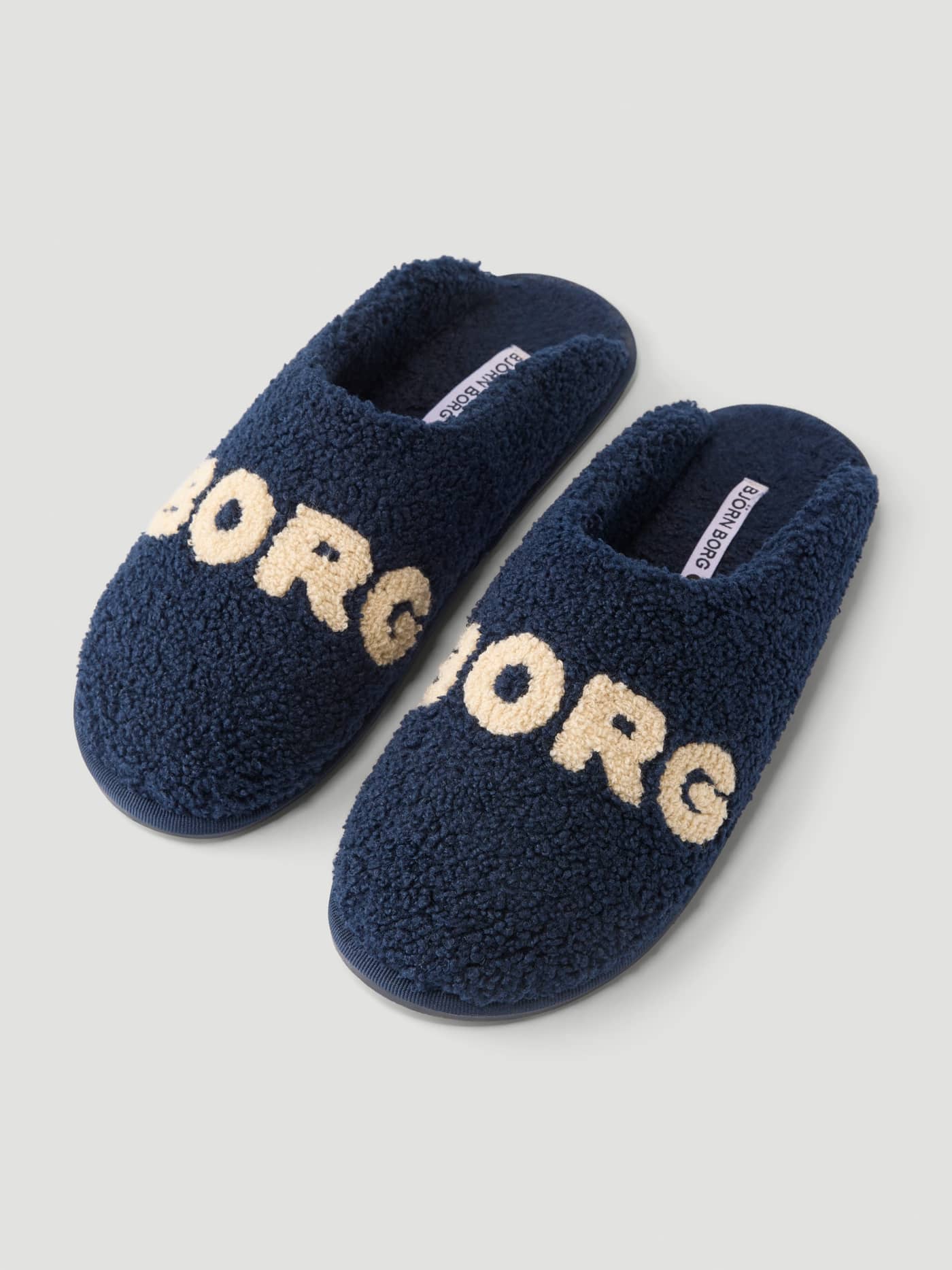 Pair of Haven Slipped in Peacoat and Tofu featuring soft pile and prominent Borg branding on the vamp. - Image 4