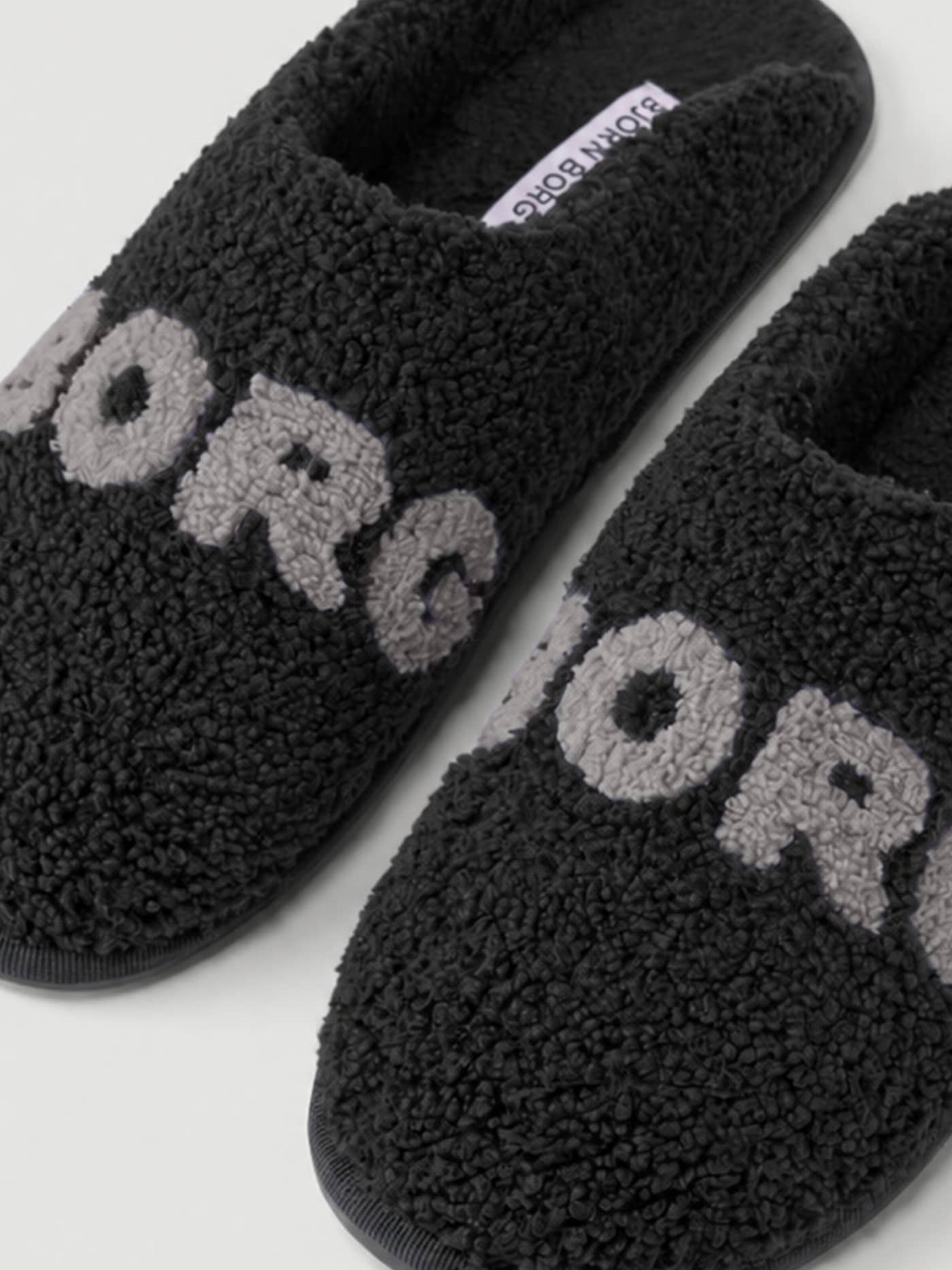 Close-up of the Haven Slipper in Black (Black) and Grey (Grey) showing the soft pile finish and Borg branding on the vamp. - Image 3