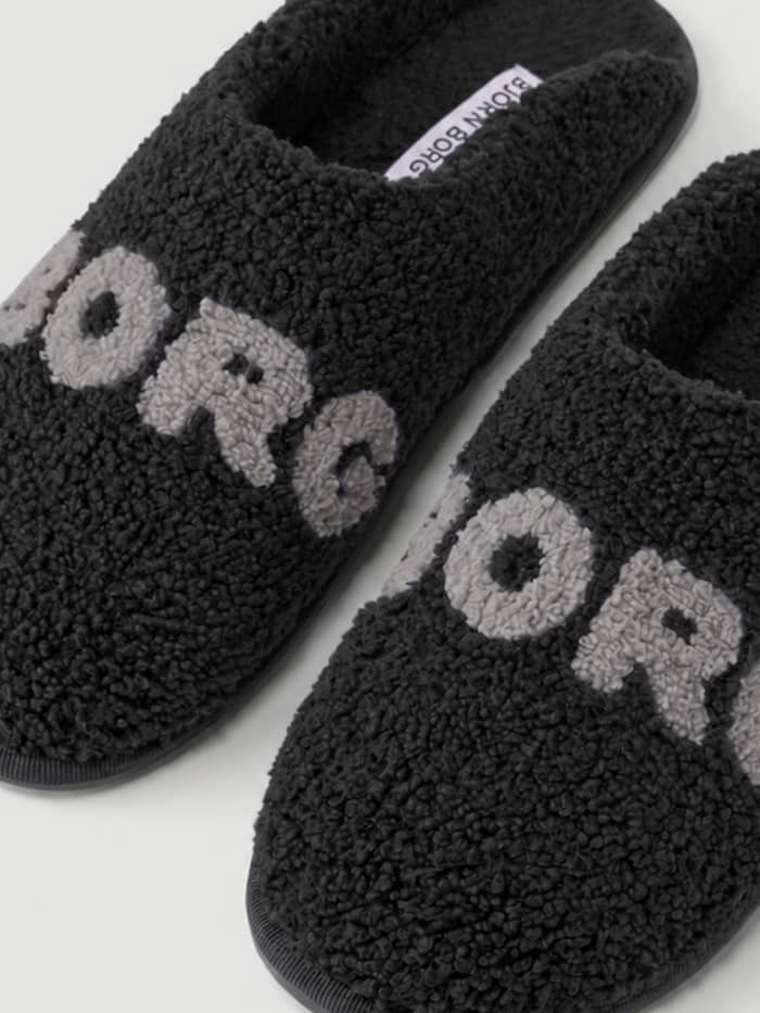 Close-up of the Haven Slipper in Black (Black) and Grey (Grey) showing the soft pile finish and Borg branding on the vamp.