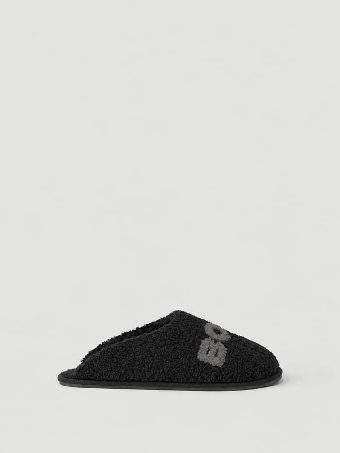 Side view of the Haven Slipper in Black (Black) with warm soft pile and Borg branding on the vamp.