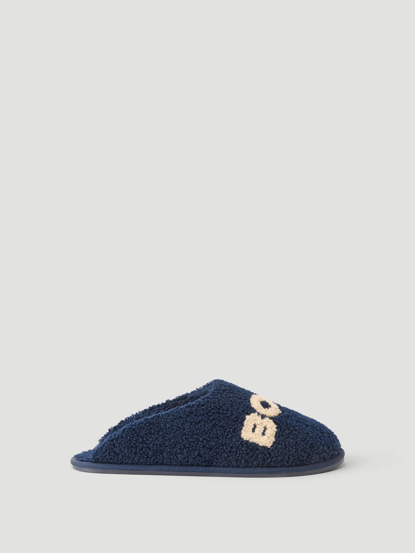 Side view of the Haven Slipper in Peacoat / Tofu with warm pile finish and Borg branding on the vamp. - Image 3