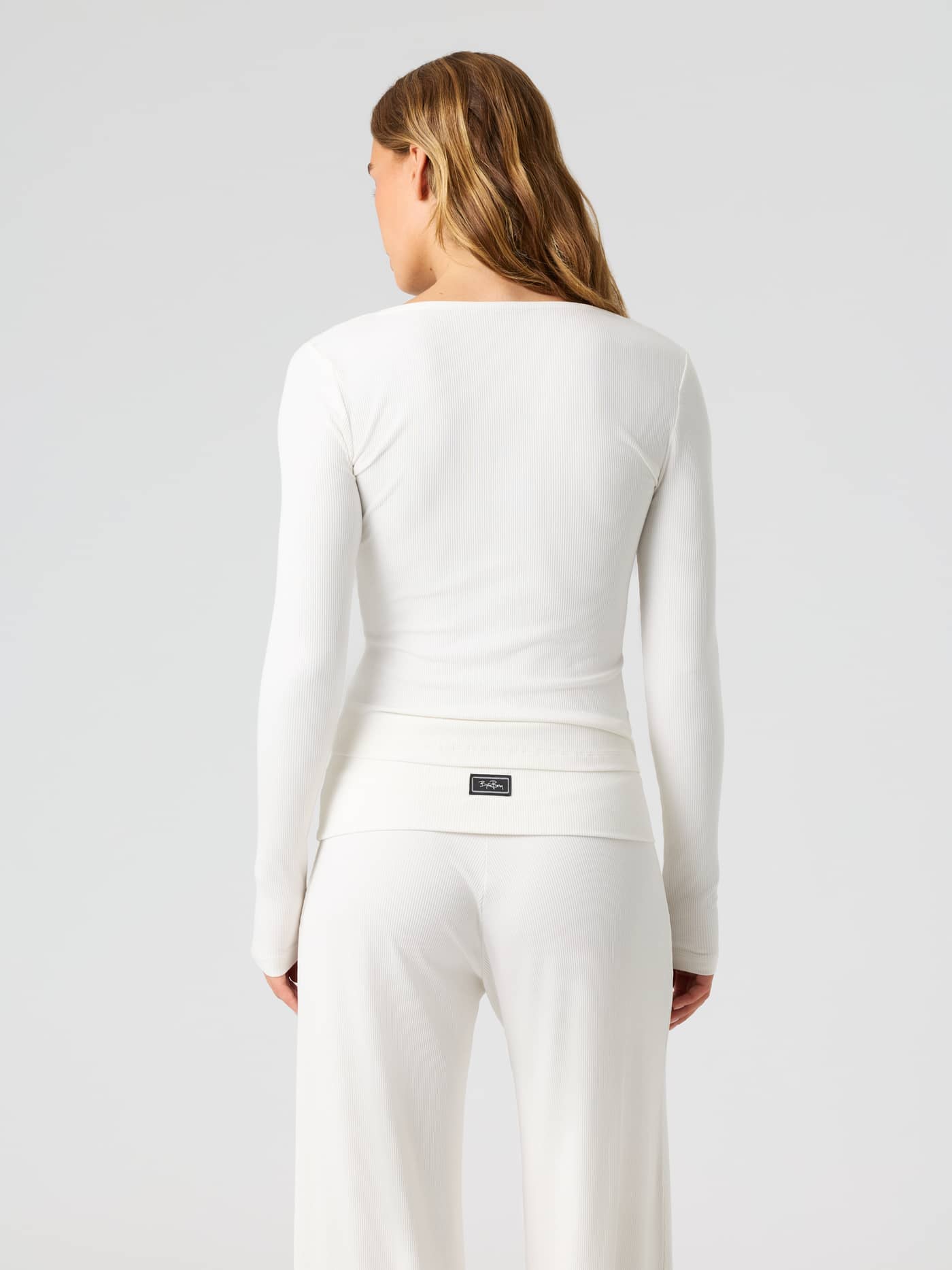 Back view of the Studio Rib Long Sleeve in Tofu (White) featuring a ribbed texture and training fit. - Image 2