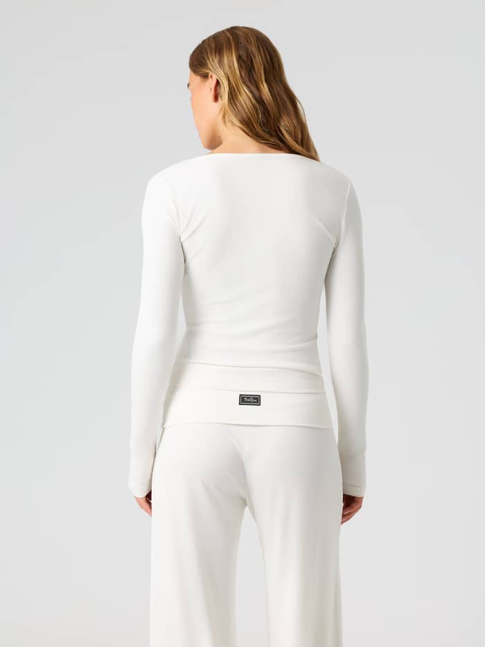 Back view of the Studio Rib Long Sleeve in Tofu (White) featuring a ribbed texture and training fit.