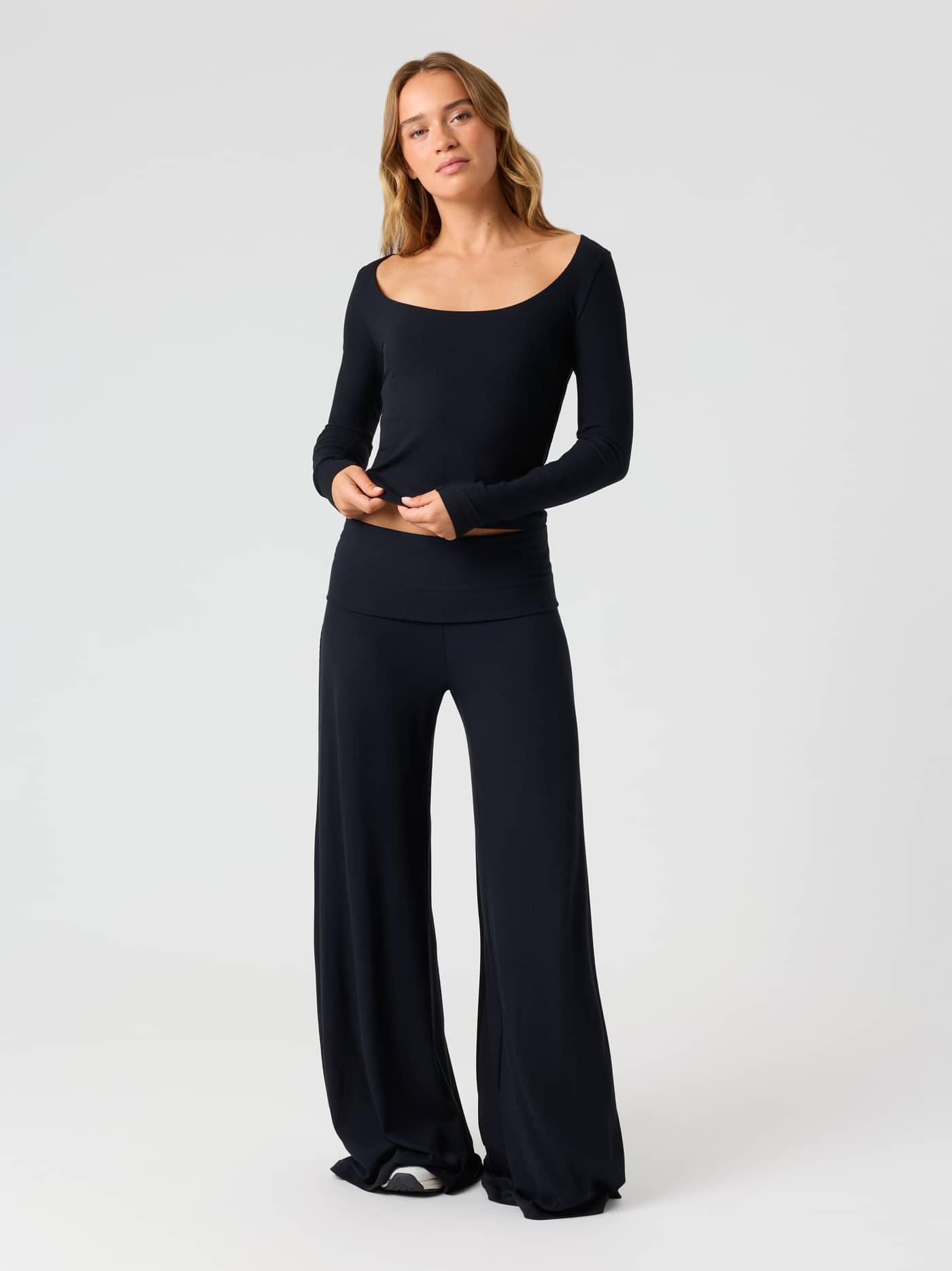 Female model wearing the Studio Rib Long Sleeve in Black Beauty (Black), showcasing the ribbed texture and long sleeves. - Image 3