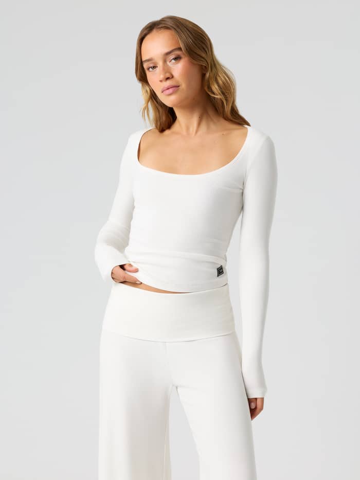 Front view of a woman wearing the Studio Rib Long Sleeve in Tofu (White) for training.