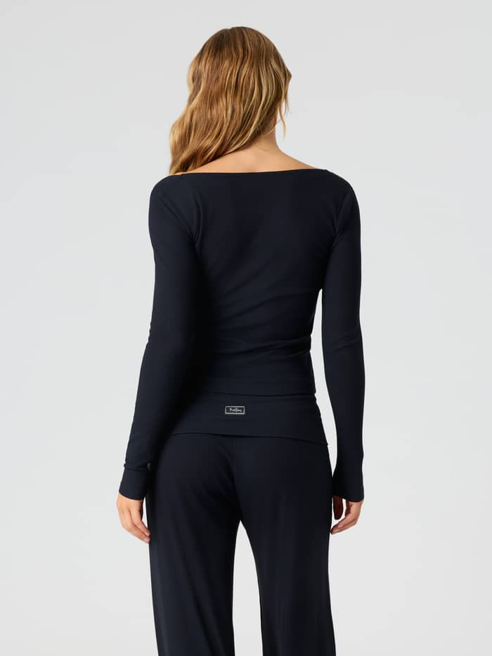 Back view of the Studio Rib Long Sleeve in Black Beauty (Black) featuring a ribbed texture and long sleeves.