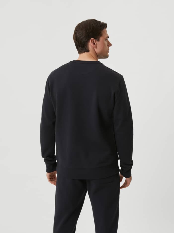 Back view of a man wearing the Björn Borg Centre Crew in Black Beauty (Black), featuring a classic regular fit. - Image 3