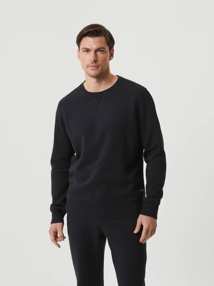 Front view of a man wearing the Björn Borg Centre Crew in Black Beauty (Black), a stylish and versatile cotton-blend sweater. - Image 2
