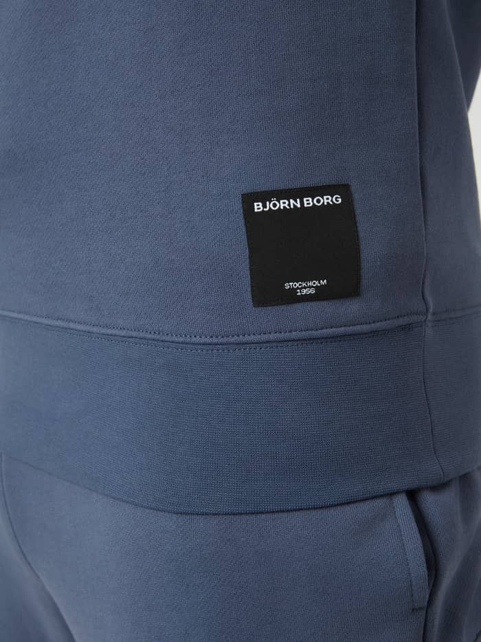 Detailed close-up of the woven logo on the Björn Borg Centre Crew in Nightshadow Blue (Blue), a soft cotton blend. - Image 5