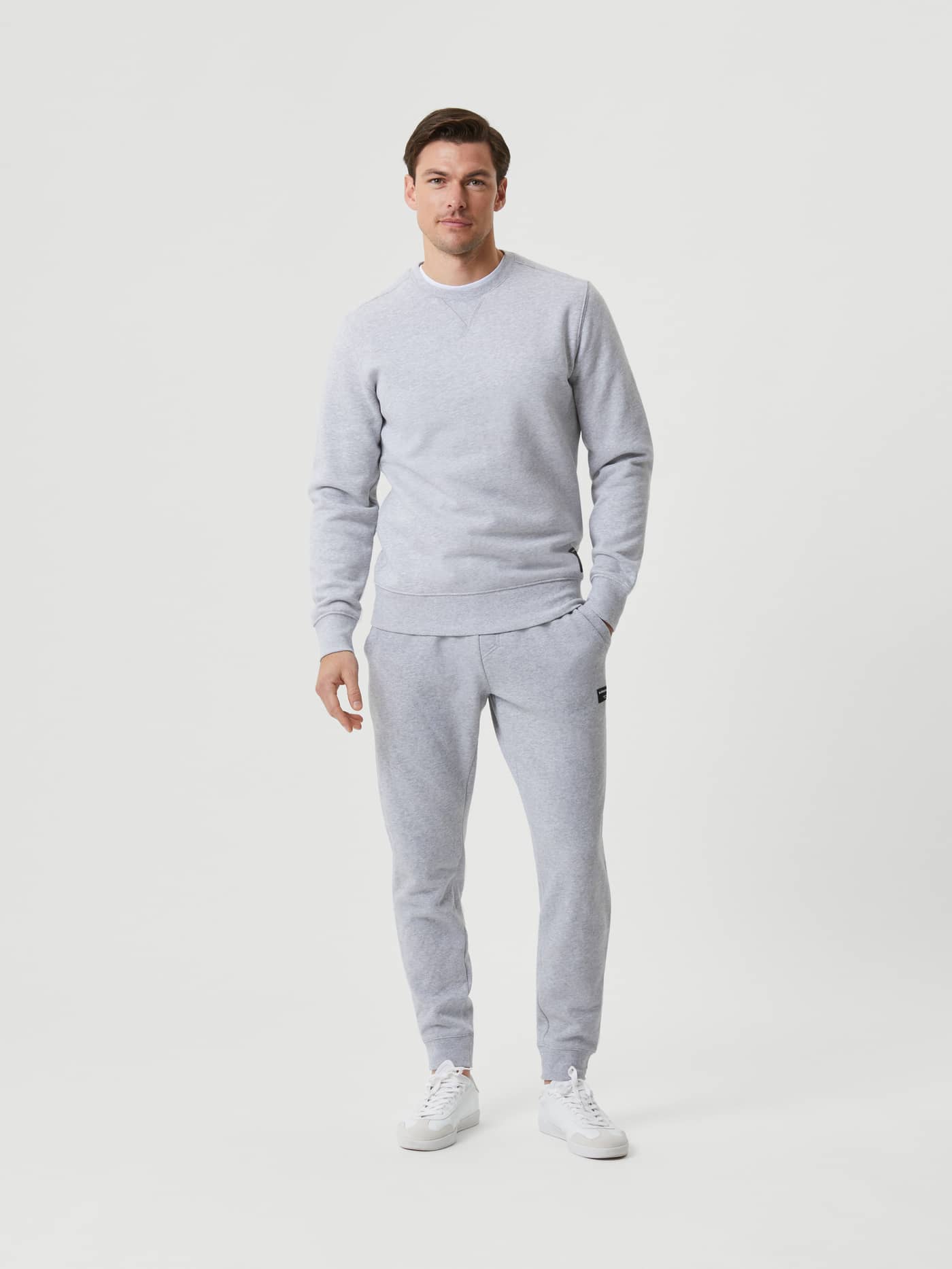Full-body front view of a man wearing the Björn Borg Centre Crew in Light Grey Melange (Grey) with matching pants. - Image 4
