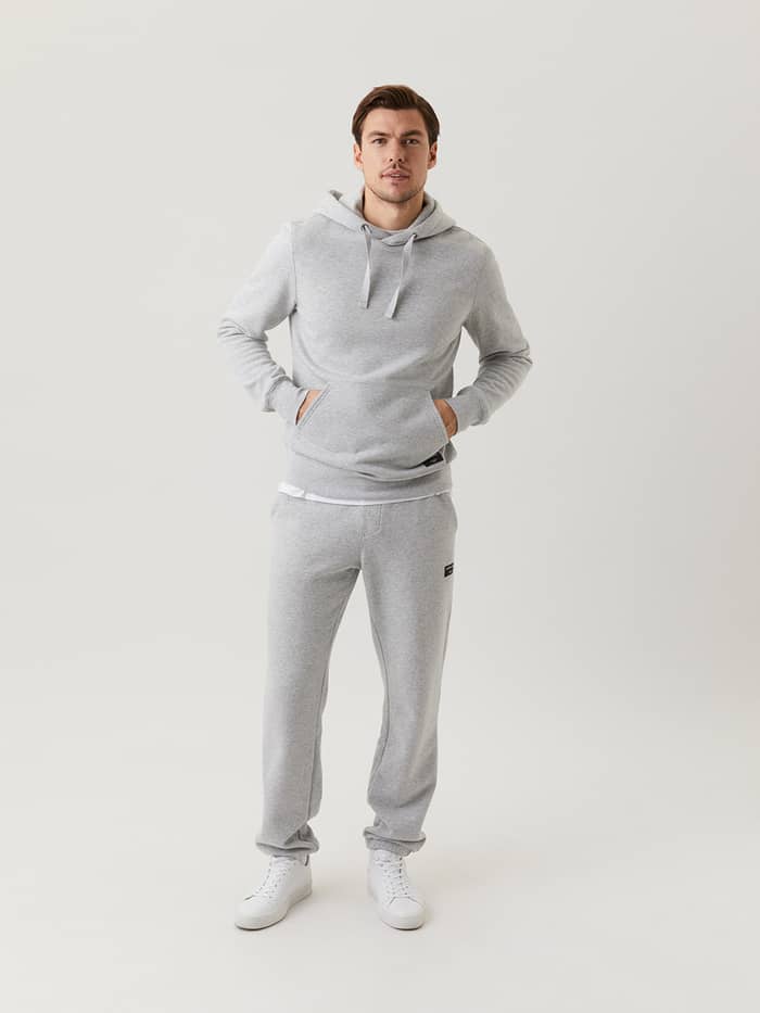 Full-body front view of a man in the Björn Borg Centre Hoodie in Light Grey Melange (Grey) for a stylish, functional fit. - Image 3