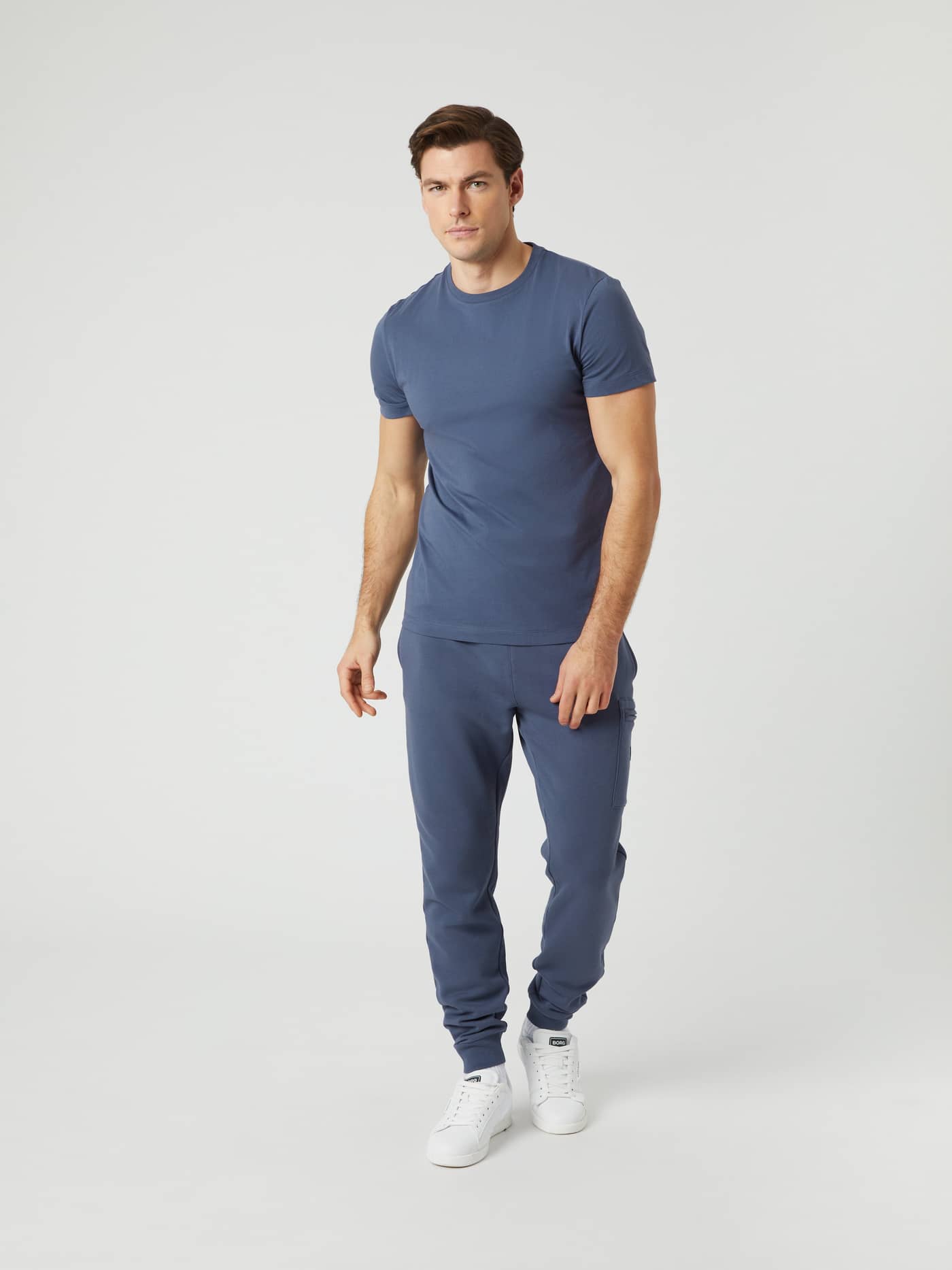 Full-body front view of a man in the regular fit cotton Björn Borg Centre T-Shirt in Nightshadow Blue (Blue) and joggers. - Image 3