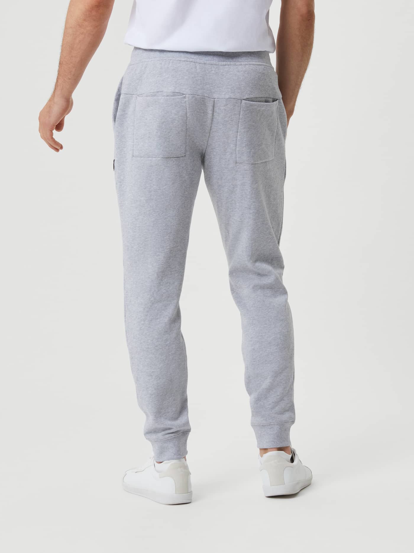 Back view of a man wearing the cotton Björn Borg Centre Tapered Pant in Light Grey Melange (Grey) with a stylish, slim fit. - Image 2