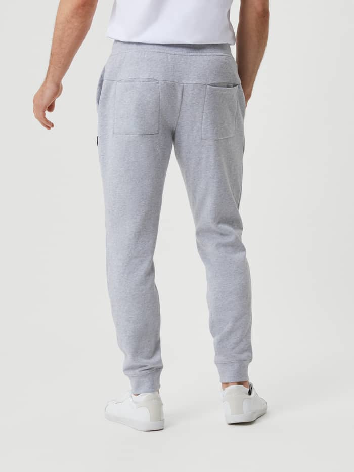 Back view of a man wearing the cotton Björn Borg Centre Tapered Pant in Light Grey Melange (Grey) with a stylish, slim fit. - Image 2