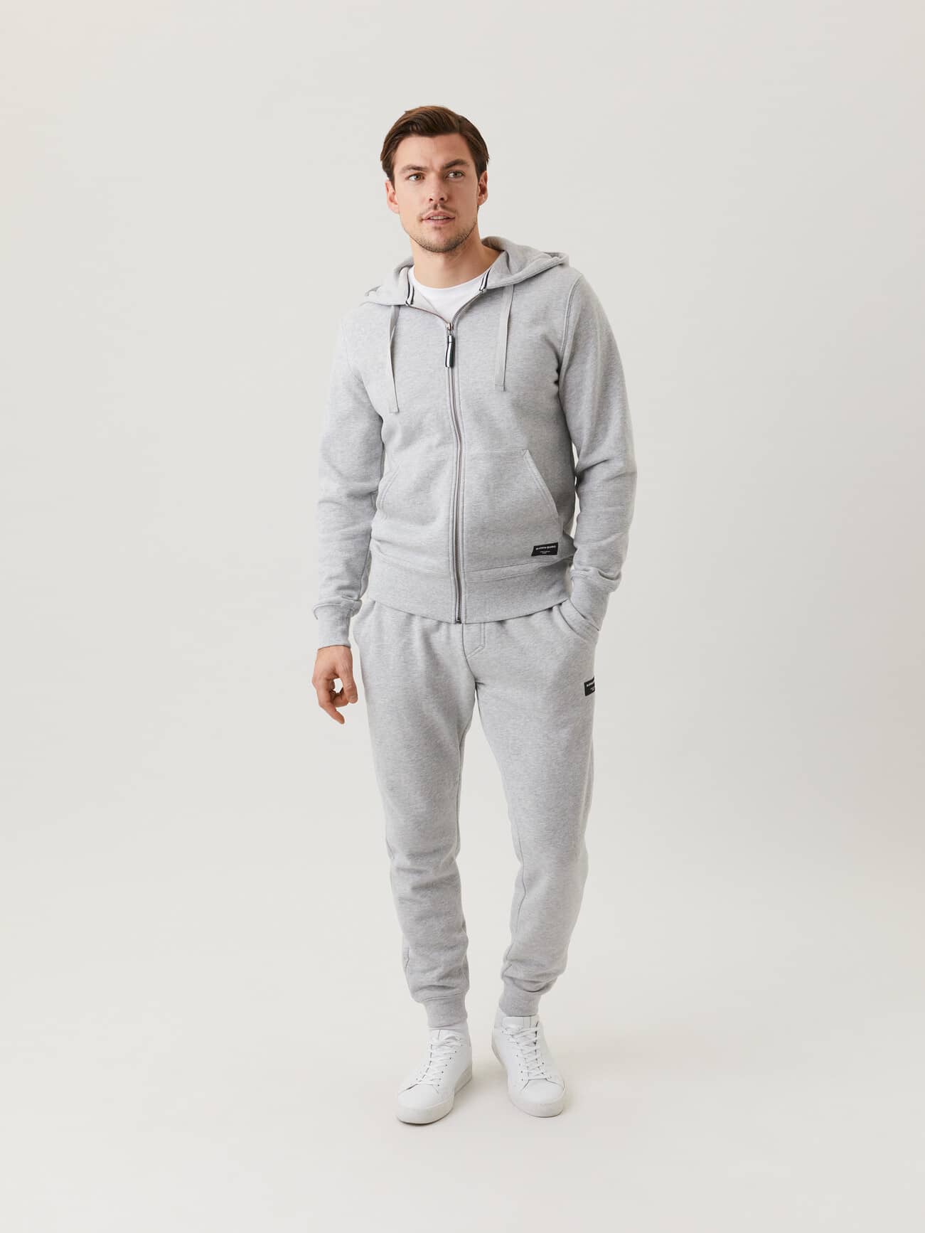 Front view of a man wearing the Björn Borg Centre Zip Hood in Light Grey Melange (Grey) for a stylish and functional fit. - Image 3