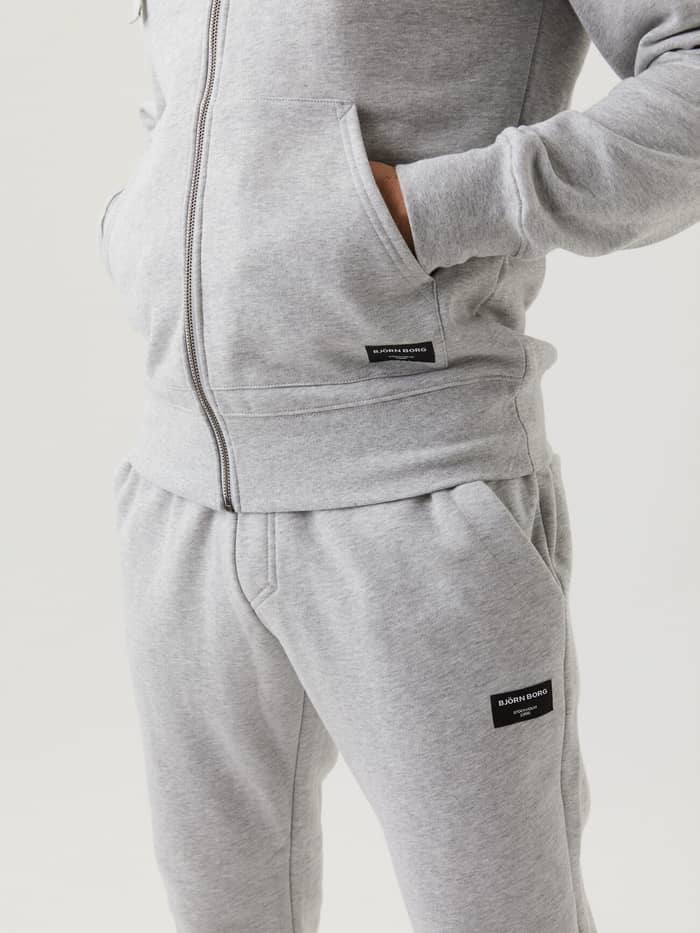 Close-up of the Björn Borg Centre Zip Hood in Light Grey Melange (Grey) showing its functional pockets and stylish fit. - Image 2