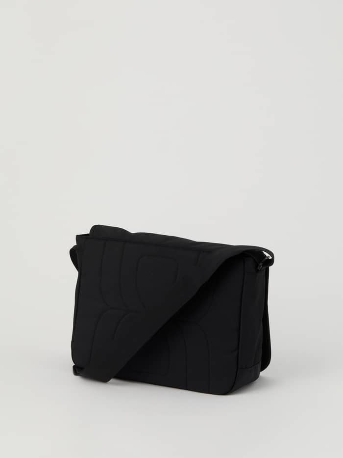Front view of the black Björn Borg Core Flapbag 12L made from recycled polyester featuring a tonal embossed logo. - Image 2