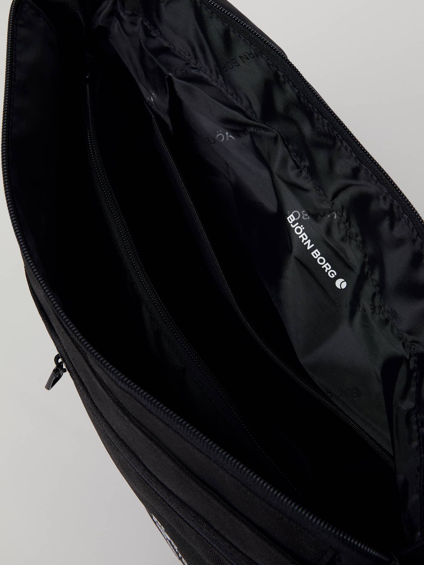 Binnenaanzicht van de Core Flapbag 12L in Zwart van gerecycled polyester met een wit Björn Borg-logo op de voering. - Image 10