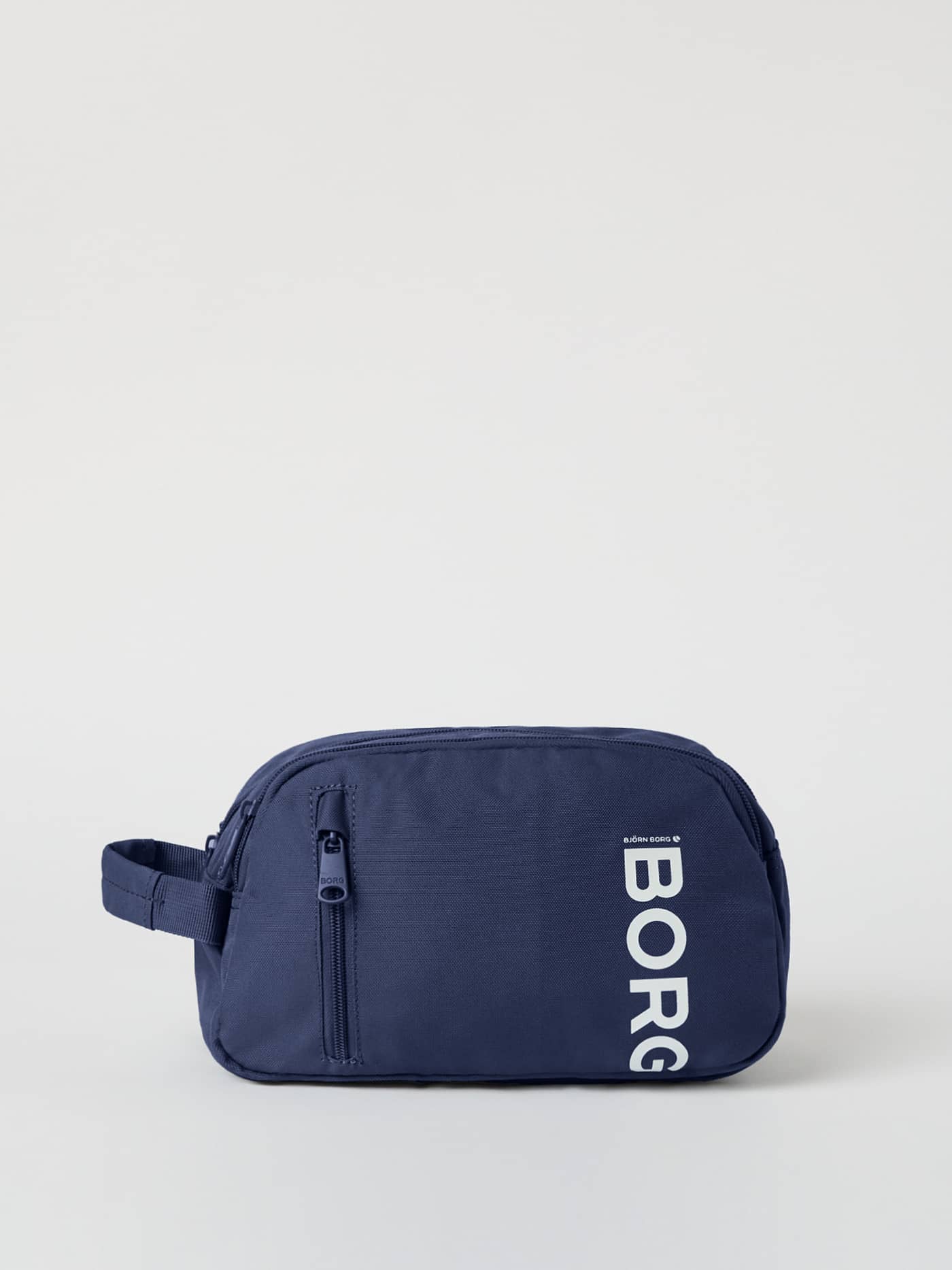 Core Wash Bag Standing in Night sky (Navy) crafted from durable recycled polyester with a prominent white BORG logo. - Image 1