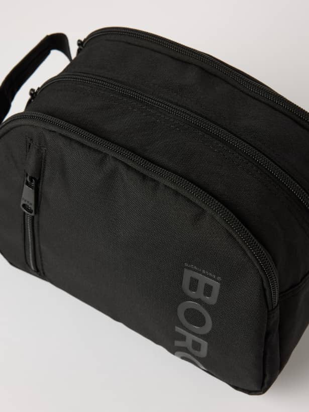 Core Wash Bag Standing in Black Beauty (Black) featuring a tonal BORG logo and durable recycled polyester construction. - Image 4
