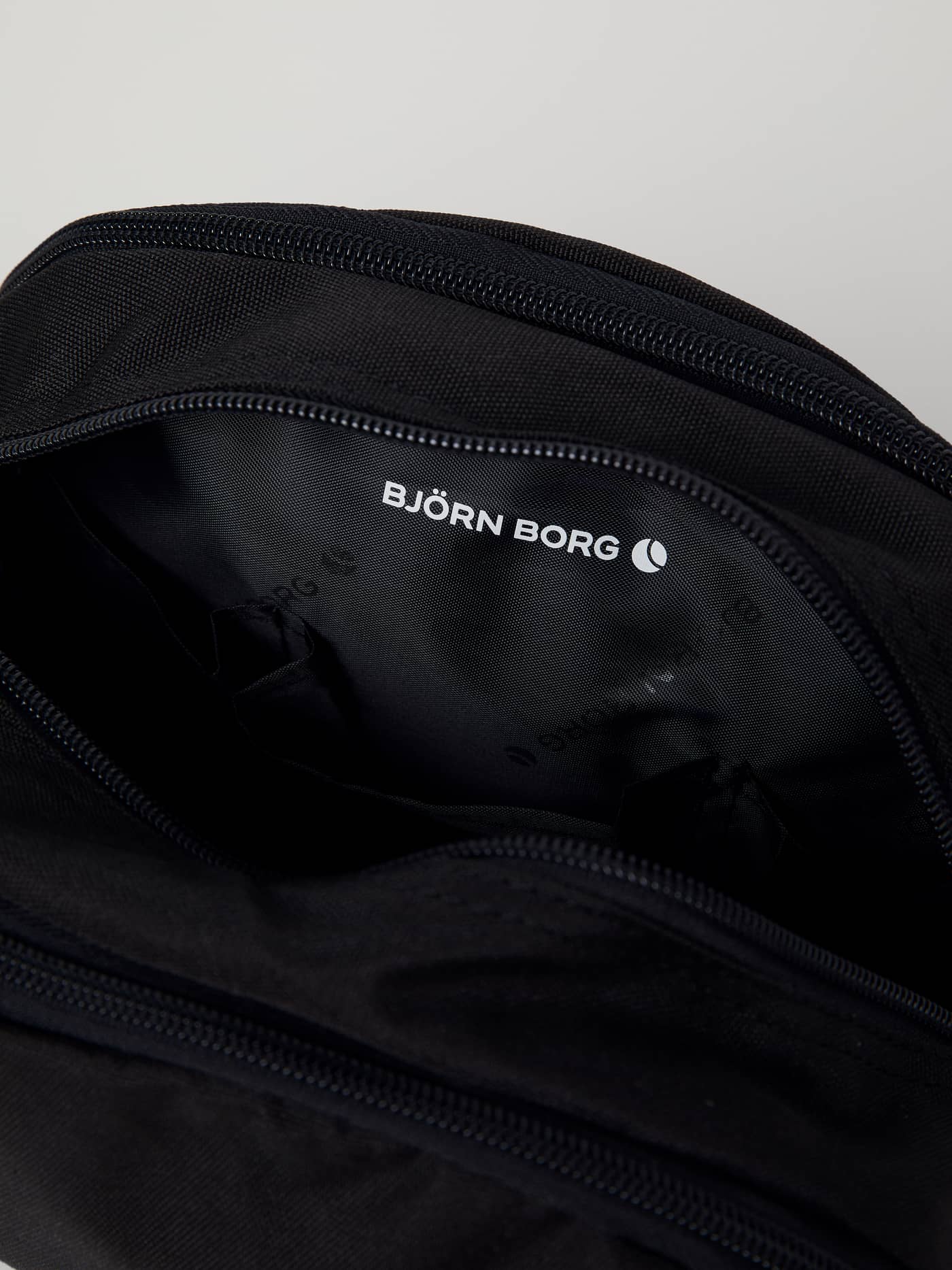 Detailed interior view of the black Core Toilet Case Standing in recycled polyester, featuring white logo branding. - Image 4