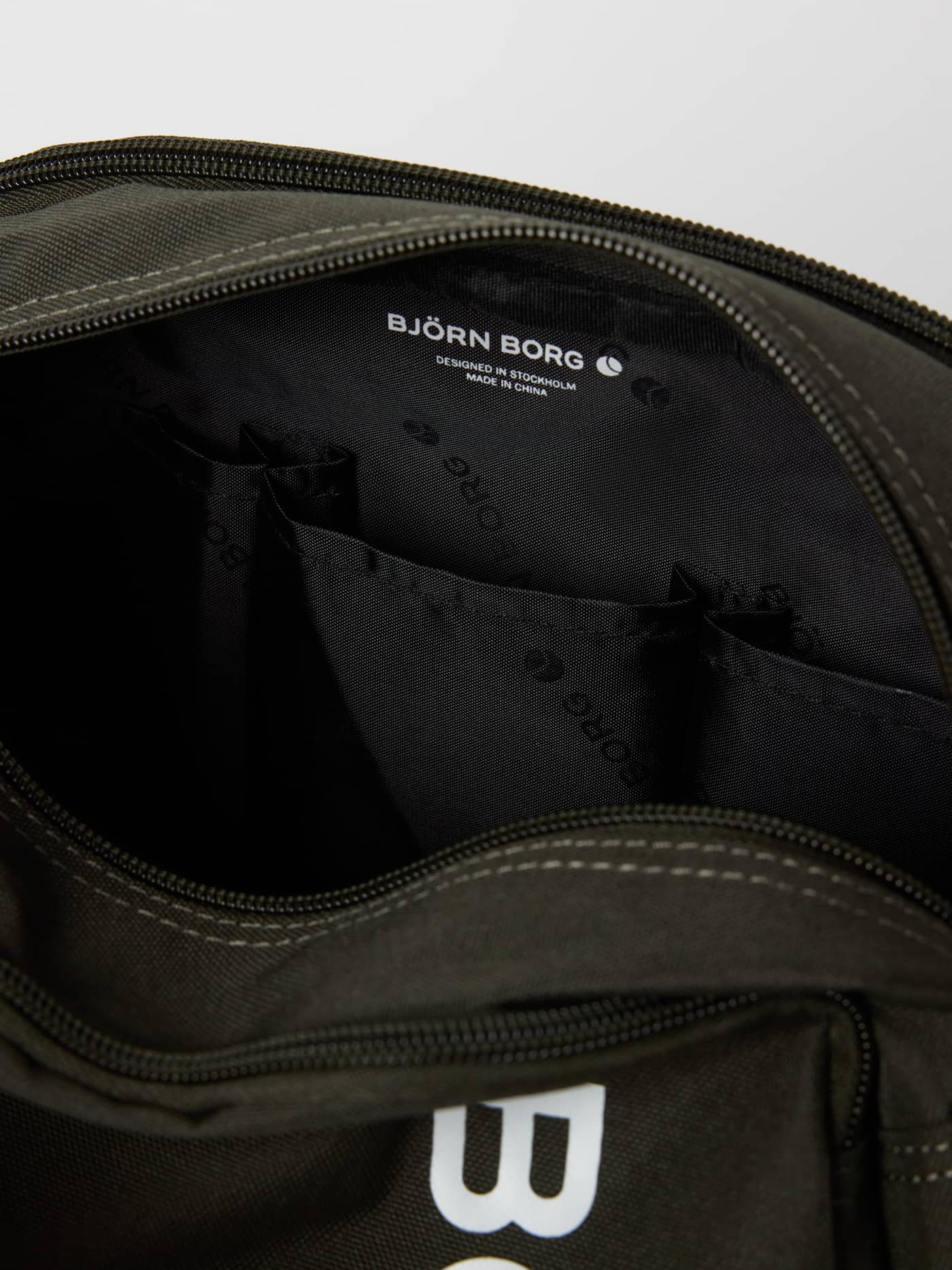 Interior view of the Core Wash Bag Standing in Forest Night (Green) showing internal organization compartments. - Image 4