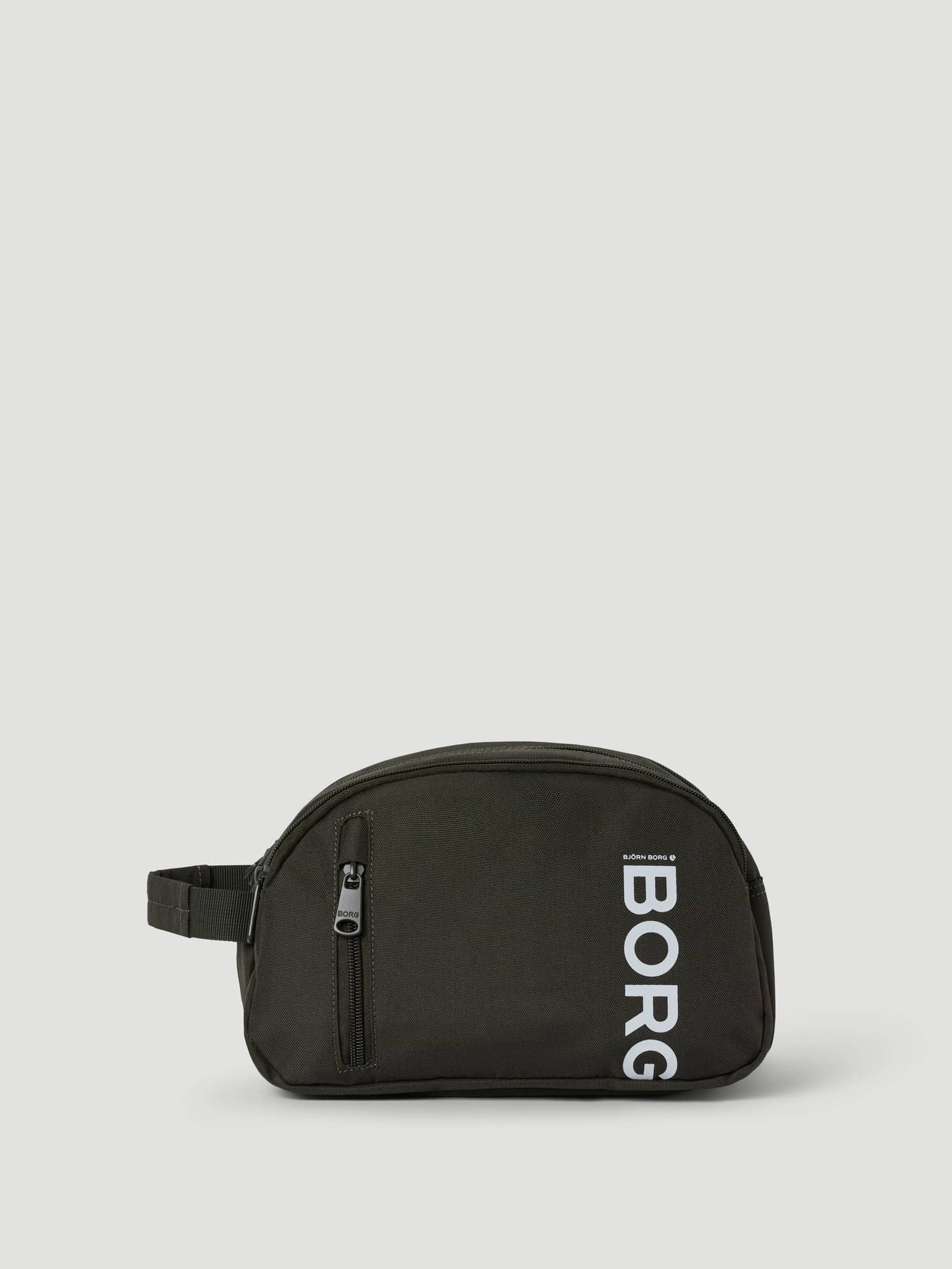 Core Wash Bag Standing in Forest Night (Green) made from recycled polyester with a white BORG logo and front zip pocket. - Image 1