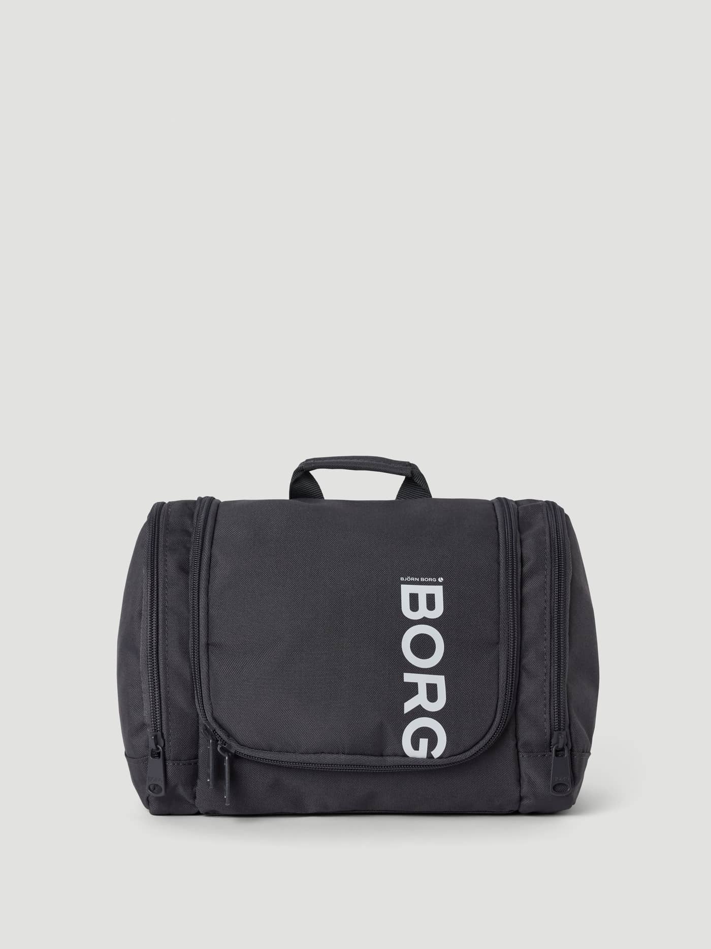 Front view of the Core Wash Bag Hanging in Asphalt (Grey), crafted from recycled polyester with a white Borg logo. - Image 1