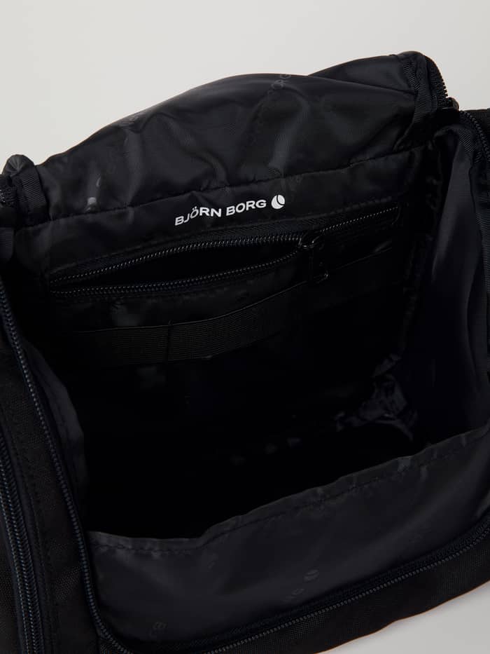 Binnenaanzicht van de Core Toilet Case Hanging in Black Beauty (Zwart) met een wit logo en ritsvak. - Image 4
