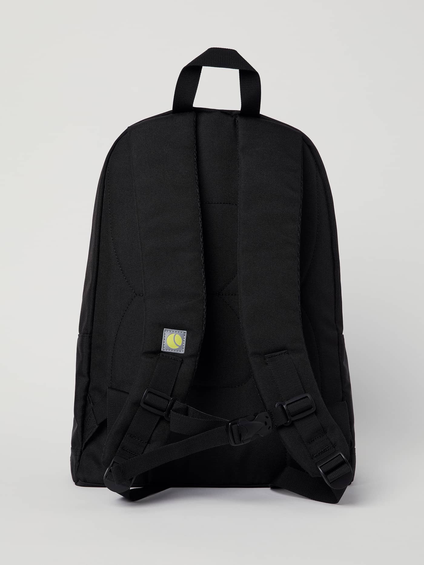 Back view of the Core Street Backpack 21L in Black Beauty (Black) in recycled polyester with a yellow tennis ball logo. - Image 4
