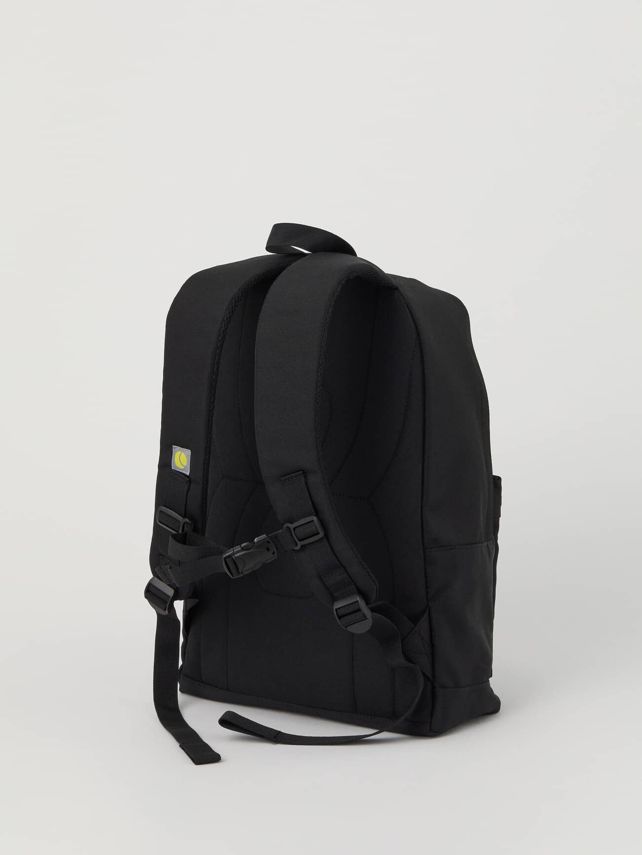 Back view of the Core Street Backpack 21L in Black Beauty (Black) in polyester with padded straps and a yellow tennis logo. - Image 3